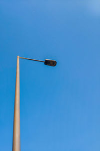 Low angle view of street light against clear blue sky