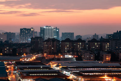 High angle view of illuminated cityscape against sky during sunset