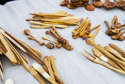 Close-up of wooden kitchen utensils for sale on table in market