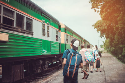 Rear view of people walking on train