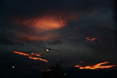 Low angle view of illuminated street light against sky at night