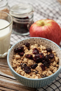 Morning breakfast with granola on wooden background