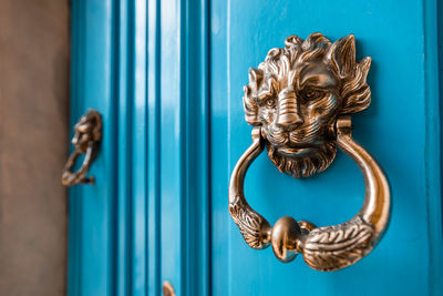 Close-up of door knocker on a blue door