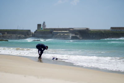 Man on beach against sky