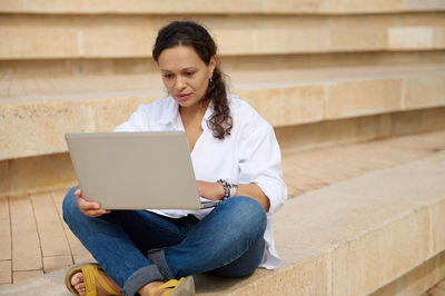 Young woman using laptop at home