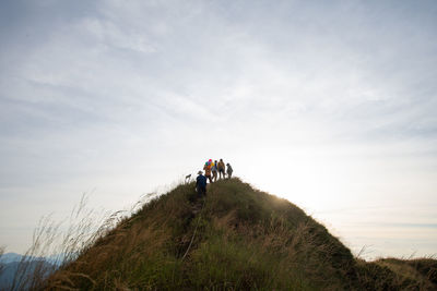 People on land against sky