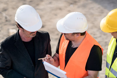 Midsection of man working with mobile phone