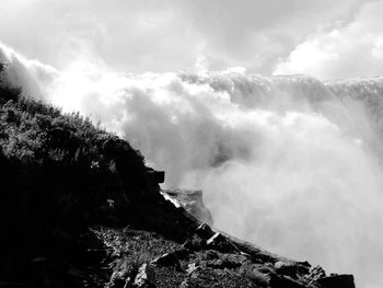 Scenic view of mountains against cloudy sky