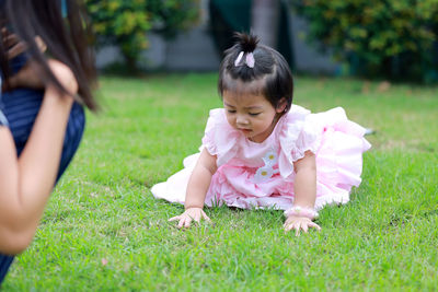 Cute girl on grassy field