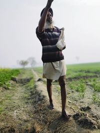 Full length of man standing on field