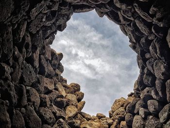 Low angle view of rock formation against sky