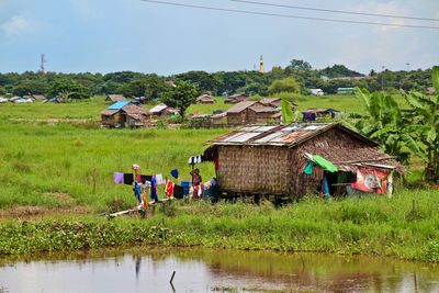 Houses on field against sky