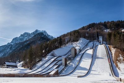 Low angle view of snow covered ski slopes against clear sky