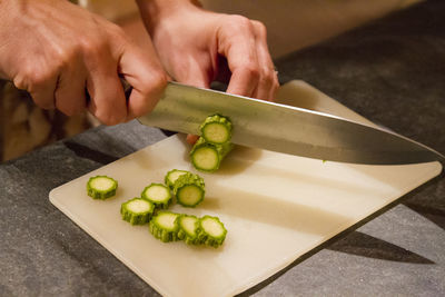 Close-up of person preparing food on cutting board