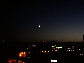 High section of illuminated city against sky at night