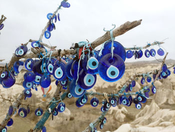 Low angle view of clothespins hanging against sky