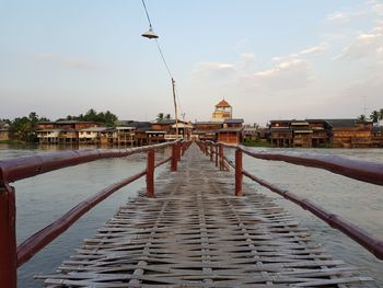 Pier over river against sky