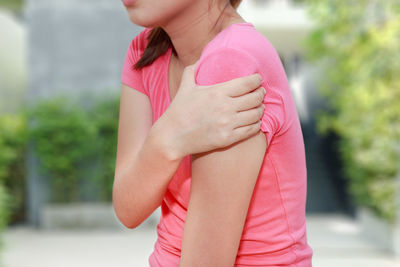 Midsection of woman suffering from arm pain