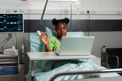 Smiling woman using laptop at home