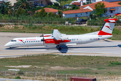 Side view of airplane on airport runway