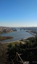 High angle view of river and buildings against clear sky