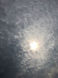 Low angle view of bright sun in sky