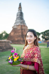 Portrait of woman in traditional clothing standing outdoors