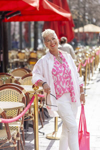 Portrait of stylish mature woman visiting sidewalk cafe