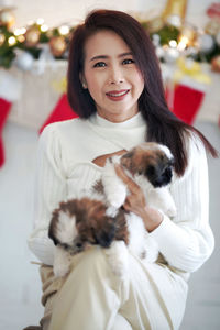 Portrait of smiling woman with dogs at home. 