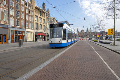 Tram driving on an empty rokin in amsterdam the netherlands 