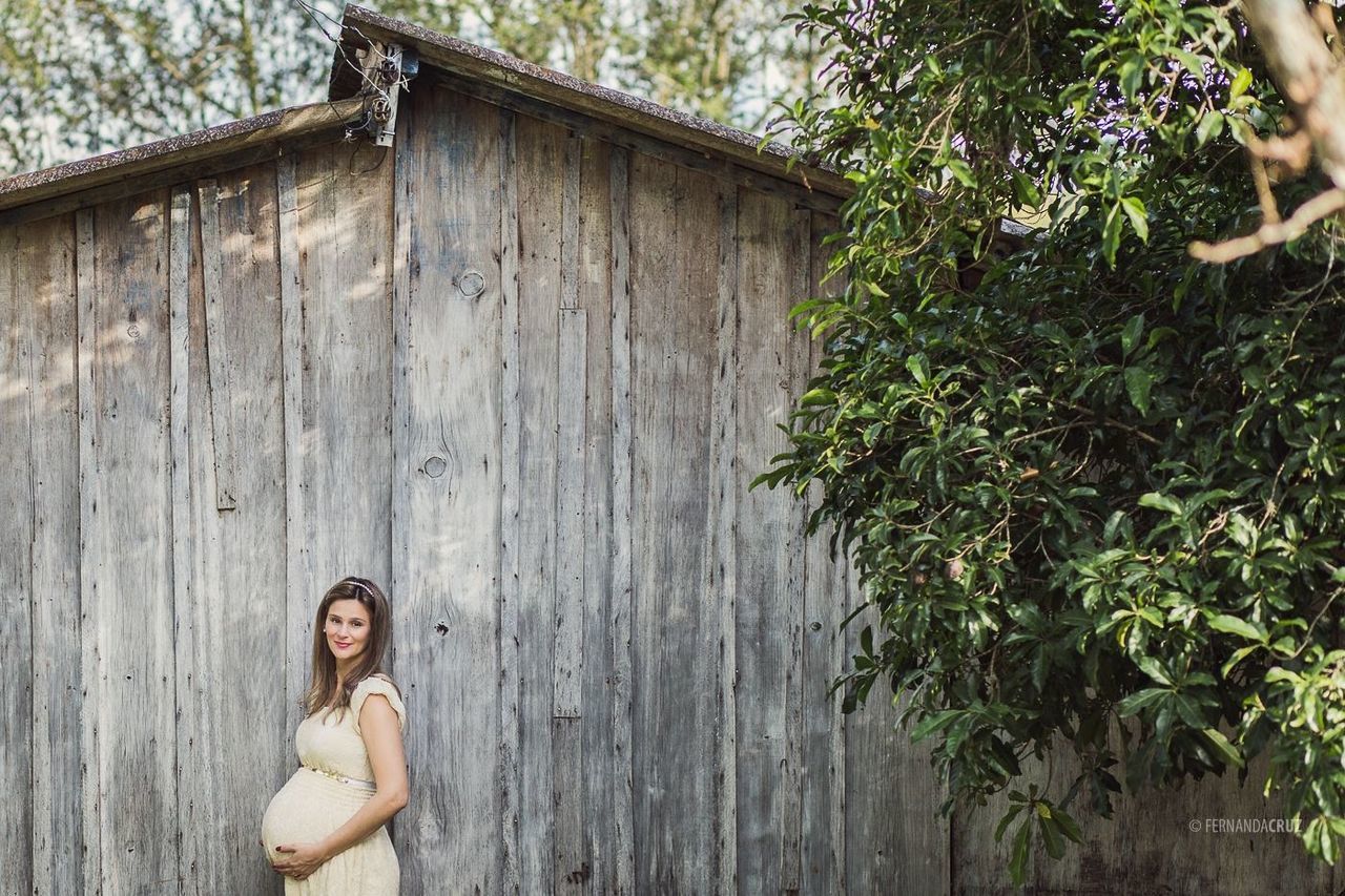 wood - material, lifestyles, person, leisure activity, tree, wooden, childhood, plant, day, young adult, standing, built structure, front view, house, outdoors, casual clothing, young women, growth