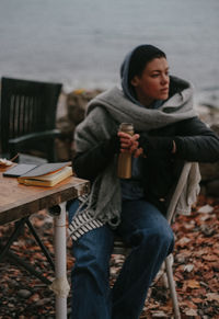 Full length of woman sitting on seat