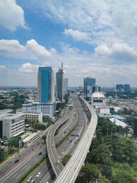 High angle view of street amidst buildings against sky