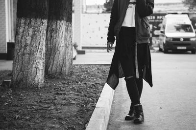 Low section of woman walking on street