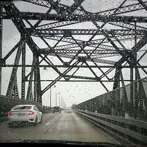 Cars on road in city against sky