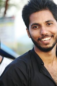 Portrait of cheerful smiling young man outdoors
