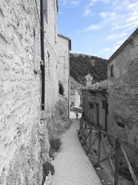 Narrow alley amidst buildings against sky