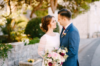 Young couple standing against white wall