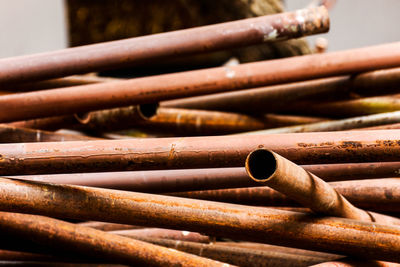 Close-up of rusty stack on wood