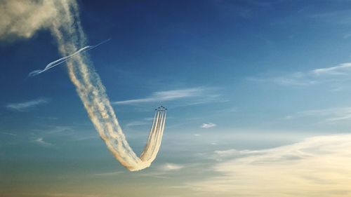 Low angle view of airplane flying against sky