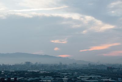 Aerial view of cityscape against sky during sunset