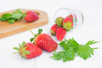 Close-up of strawberries on table against white background