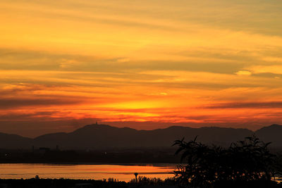 Scenic view of dramatic sky over sea during sunset