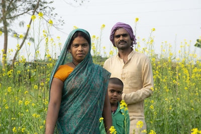 Young couple standing on field