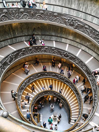 High angle view of people on spiral staircase of building