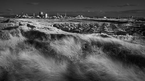 A general view of the closed down steelworks in redcar, and the fishermans huts at south gare.