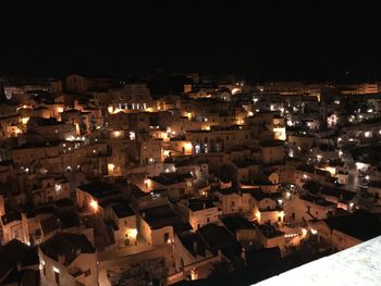 High angle view of illuminated townscape against sky at night