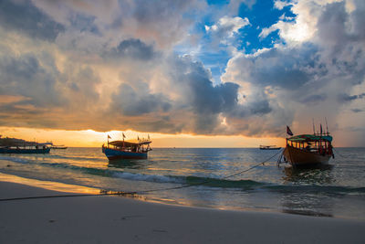 Koh rong island, cambodia at sunrise. strong vibrant colors, boats and ocean