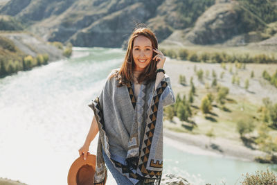 Portrait of smiling young woman standing outdoors