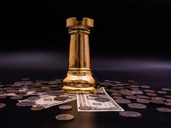 Close-up of coin on table against black background